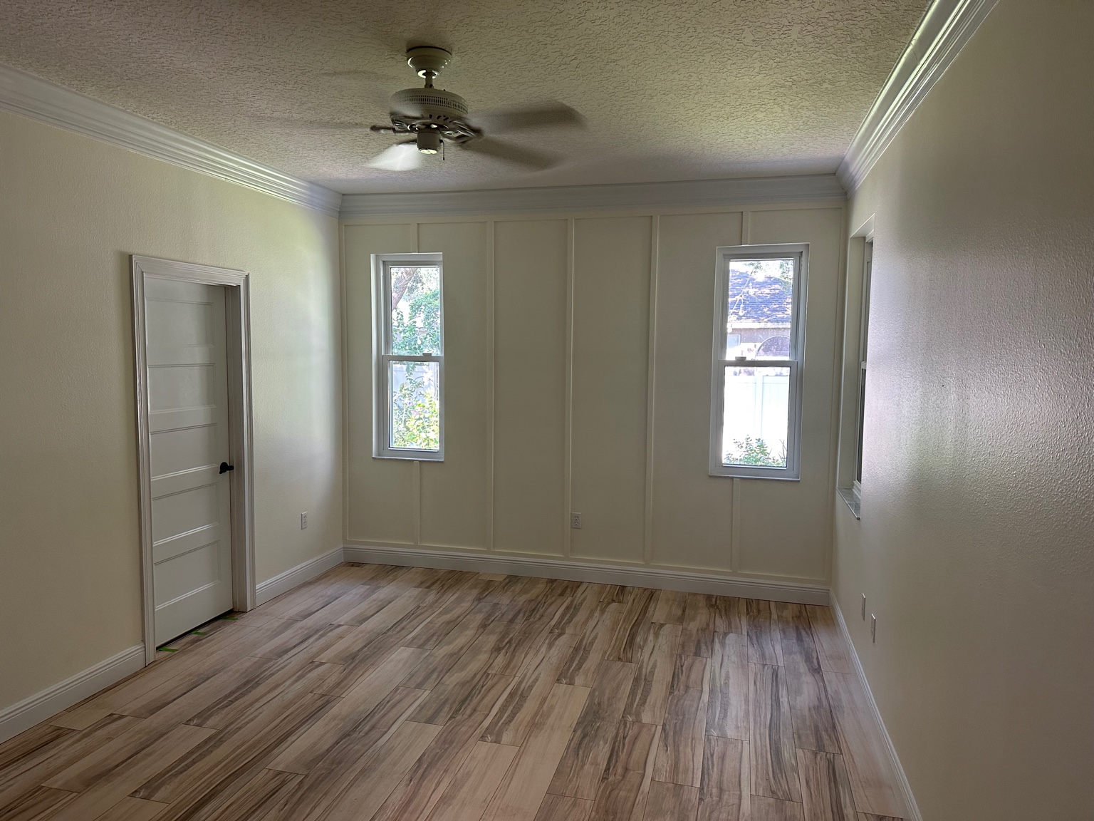 Room with board and batten wall and crown molding