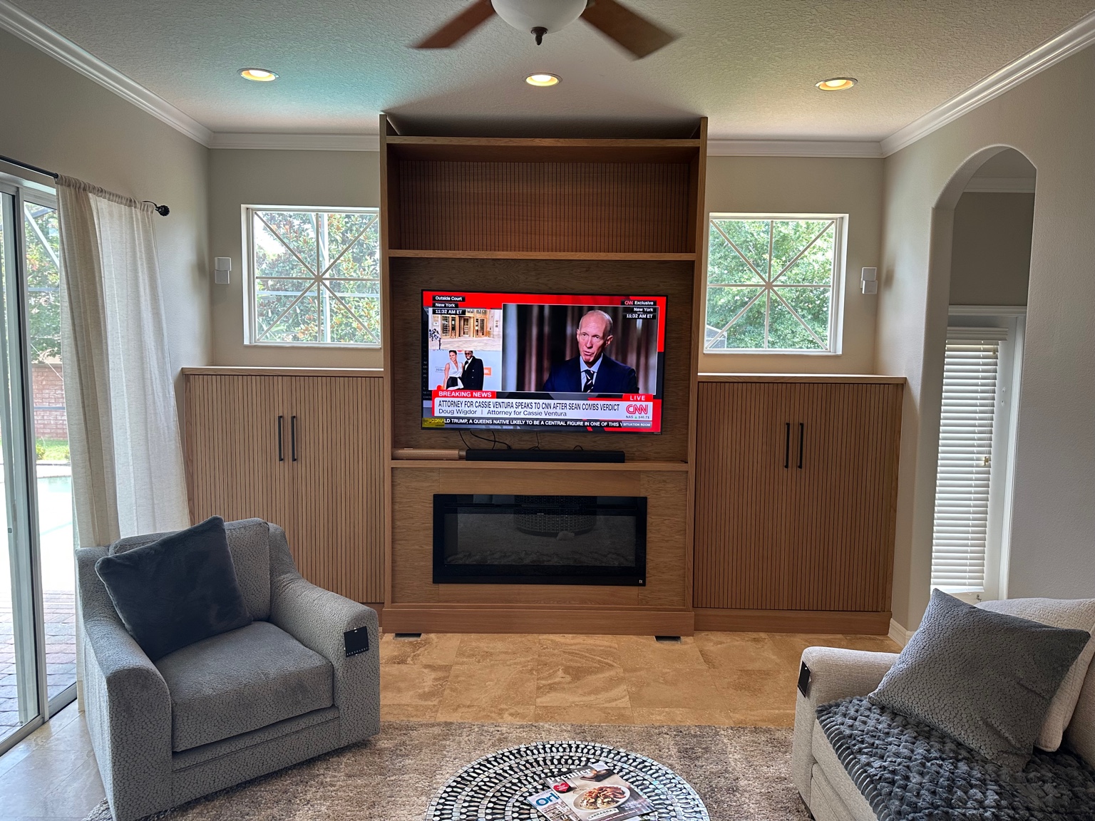Wood slatted media wall with fireplace and TV
