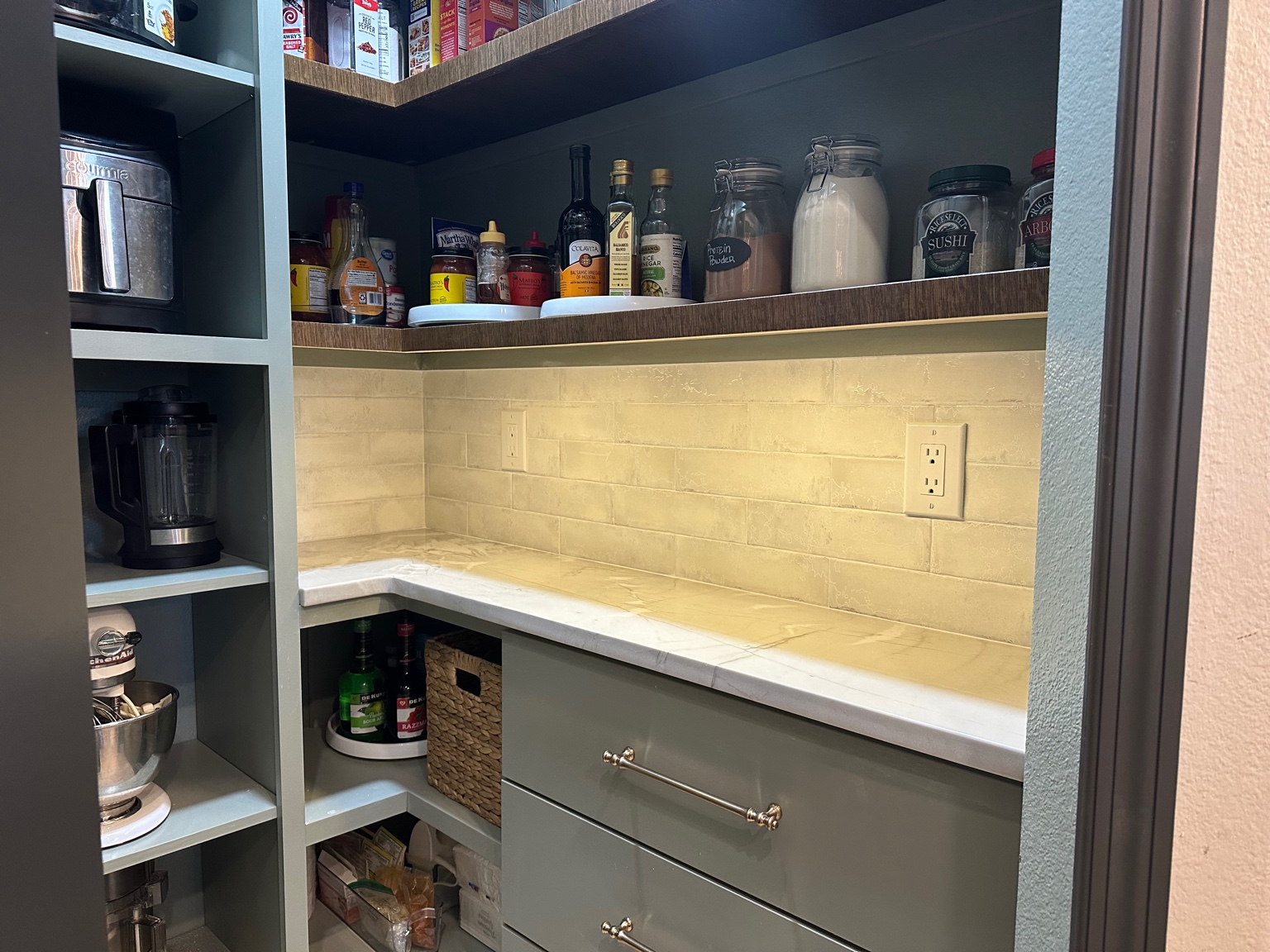 Corner of custom pantry shelving and countertop