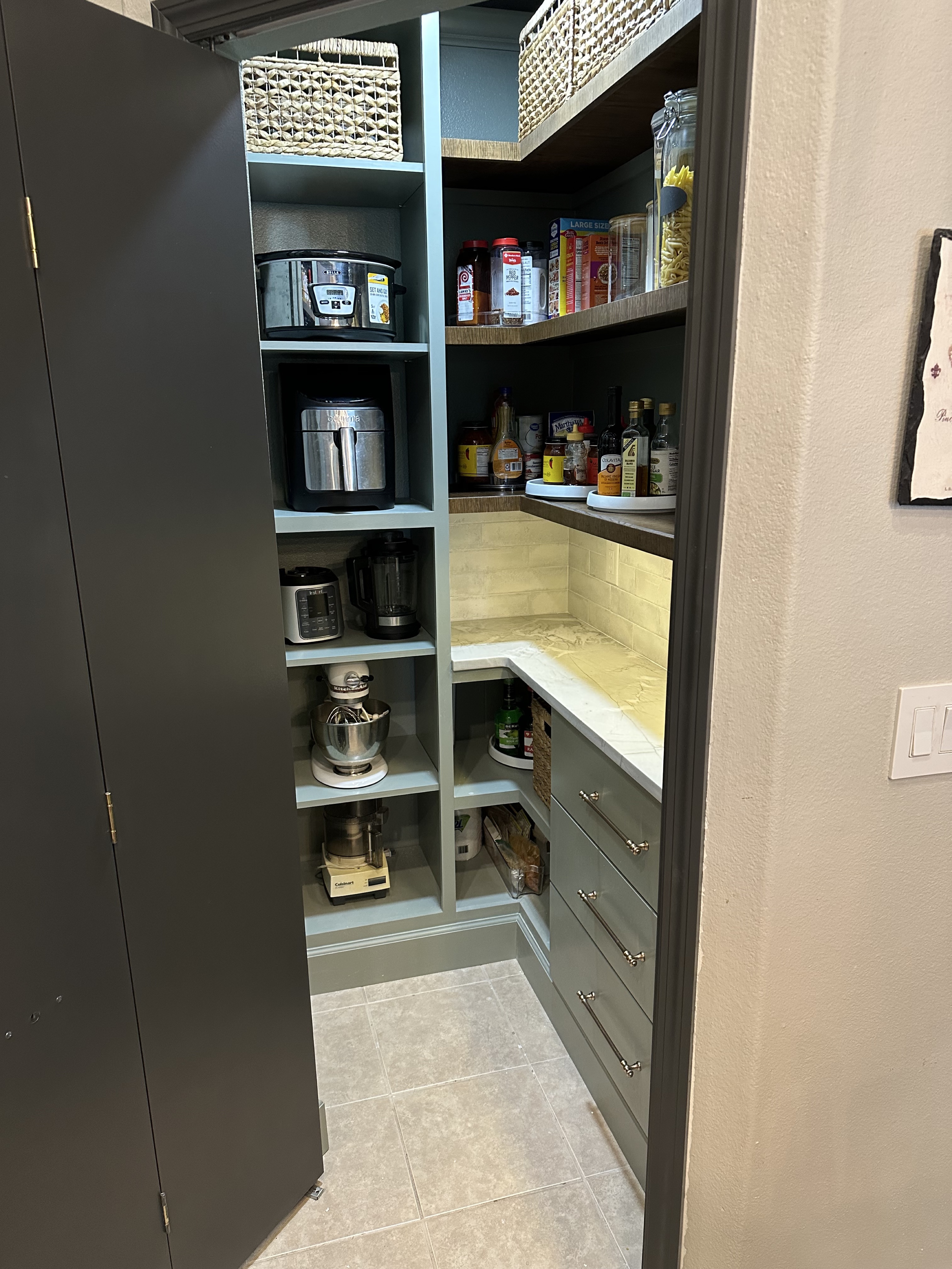 Wide view of custom walk-in pantry with shelving